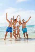 young happy friends havin fun on the beach