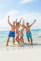 young happy friends havin fun on the beach