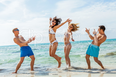 young happy friends havin fun on the beach