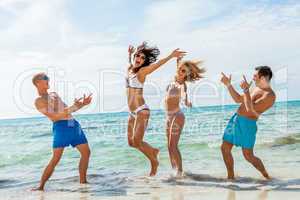 young happy friends havin fun on the beach