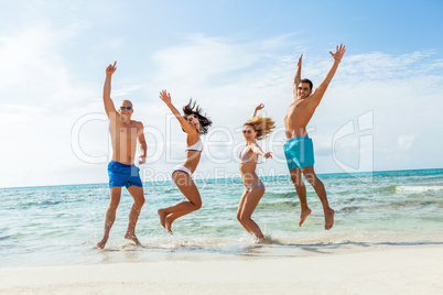 young happy friends havin fun on the beach