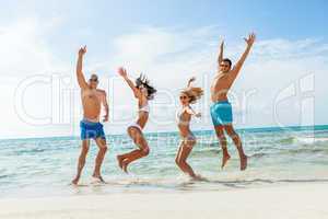 young happy friends havin fun on the beach