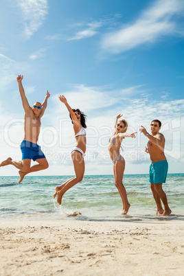 young happy friends havin fun on the beach