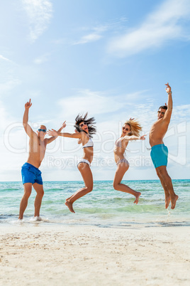 young happy friends havin fun on the beach