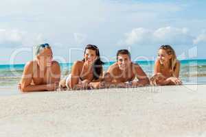 young happy friends havin fun on the beach