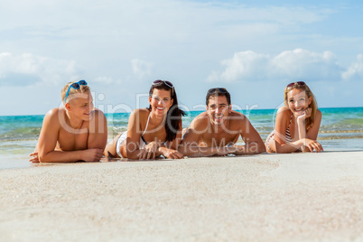 young happy friends havin fun on the beach