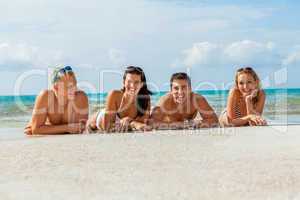 young happy friends havin fun on the beach