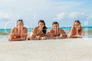 young happy friends havin fun on the beach