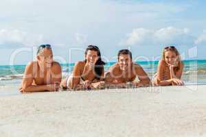 young happy friends havin fun on the beach