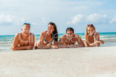 young happy friends havin fun on the beach