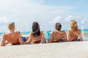 young happy friends havin fun on the beach