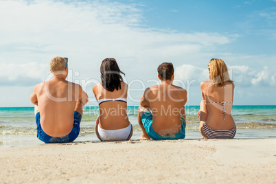 young happy friends havin fun on the beach