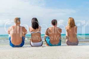 young happy friends havin fun on the beach