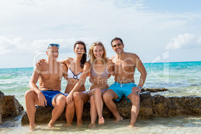 young happy friends havin fun on the beach