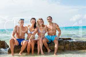 young happy friends havin fun on the beach