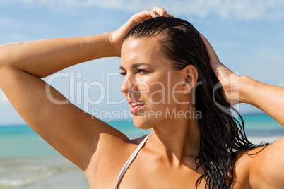 Young woman looking far away in the beach