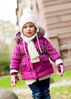 cute little child in pink jacket and hat outdoor