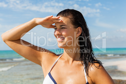 Young woman looking far away in the beach