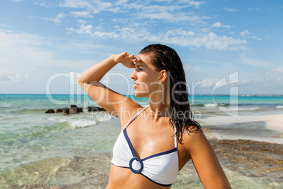 Young woman looking far away in the beach