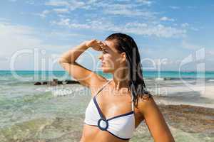 Young woman looking far away in the beach