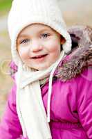 cute little girl with hat and scarf in autumn winter