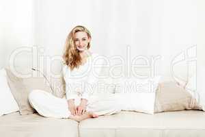 beautiful blond woman sitting on couch