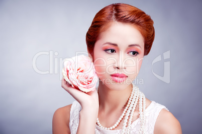 pretty asian woman with flower and pearls