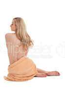 young blonde woman sitting on towel naked back isolated