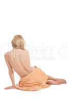 young blonde woman sitting on towel naked back isolated