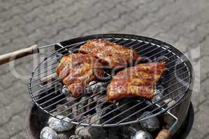 barbecue grill wiht meat outside in summer