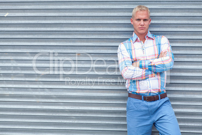 attractive young adult man with blue eyes standing outdoor