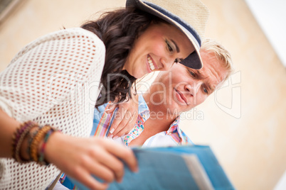 young attractive tourist couple with city map in summer