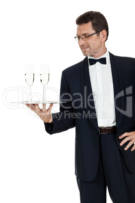 adult male waiter serving two glass of champagne isolated