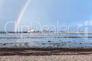 Rainbow over tidal mud flats at the coast