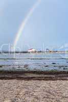 Rainbow over tidal mud flats at the coast