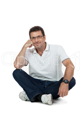 attractive healthy adult man sitting on floor with jeans isolated