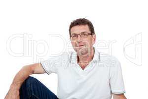 attractive healthy adult man sitting on floor with jeans isolated