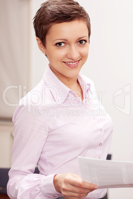 brunette business woman standing and smiling