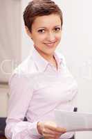 brunette business woman standing and smiling