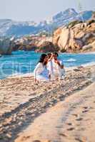 happy young family with daughter on beach in summer