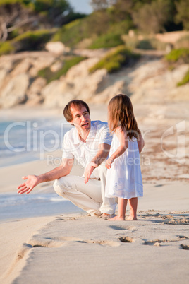 happy family father and daughter on beach having fun