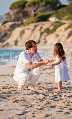 happy family father and daughter on beach having fun