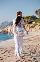 happy young family with daughter on beach in summer