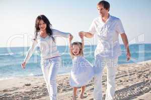 happy young family with daughter on beach in summer