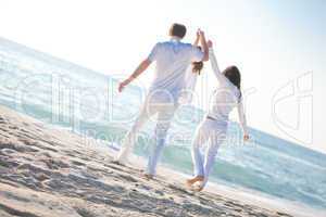 happy young family with daughter on beach in summer