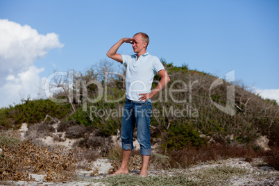 young man is relaxing outdoor in dune in summer