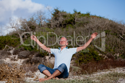 young man is relaxing outdoor in dune in summer