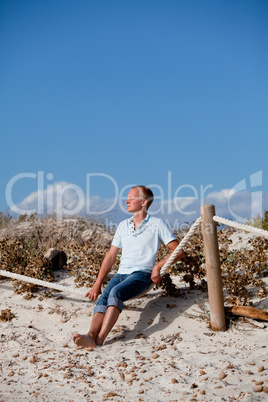 young man is relaxing outdoor in dune in summer