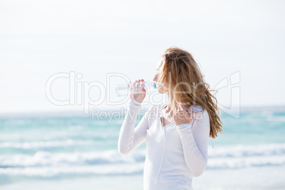 beautiful young woman drinking water in summer