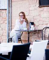 young woman is drinking coffee outdoor in summer